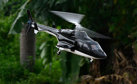 Airwolf GPS RC  helicopter flying over lush green forest.