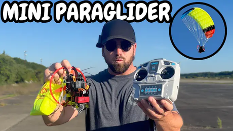 Jay Kujan holding a mini RC paraglider with a bright yellow and red canopy, alongside a remote controller, with an inset image showing the paraglider in flight against a clear sky