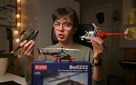 RC helicopter size comparison showing a micro and small model held by a reviewer.