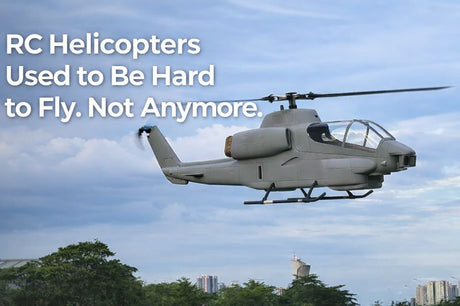 A high-performance FLISHRC FL500 HueyCobra giant scale RC helicopter hovering outdoors against a cloudy sky background.