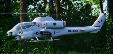 Scale RC helicopter flying in a forest setting