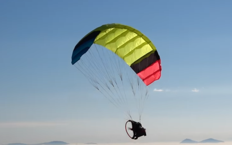 The RC paraglider flying in a clear sky